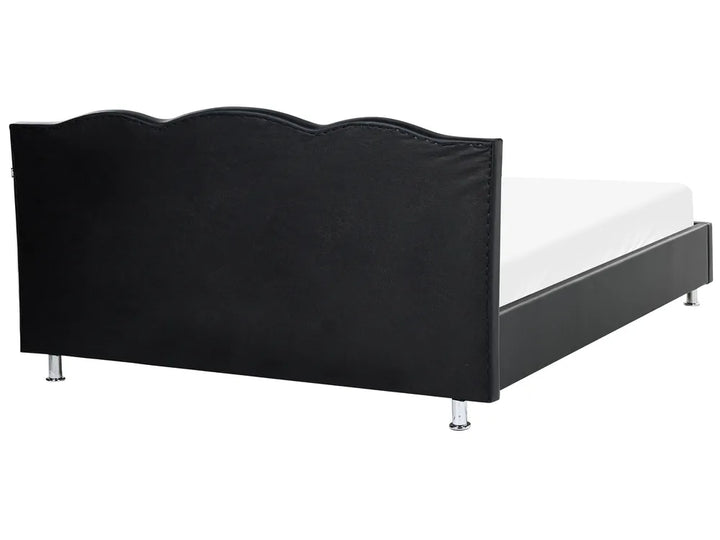 Black bed frame with white mattress on a white background