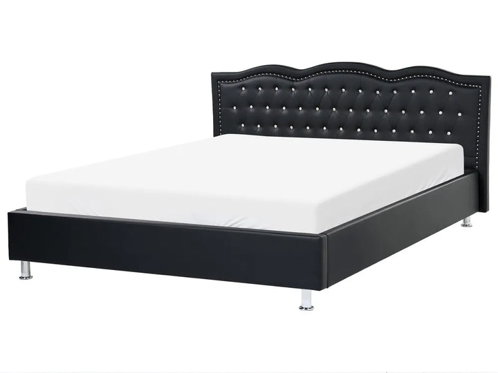 Black bed frame with tufted design on a white background