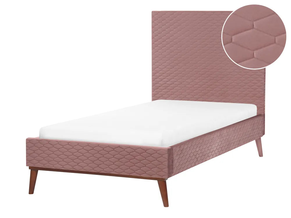 Pink quilted bed with white mattress on a white background