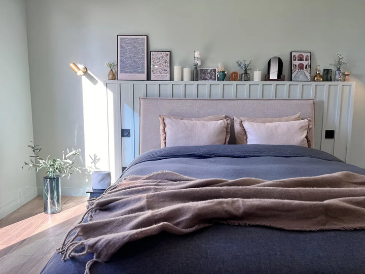 EU king bed with tall beige fabric headboard