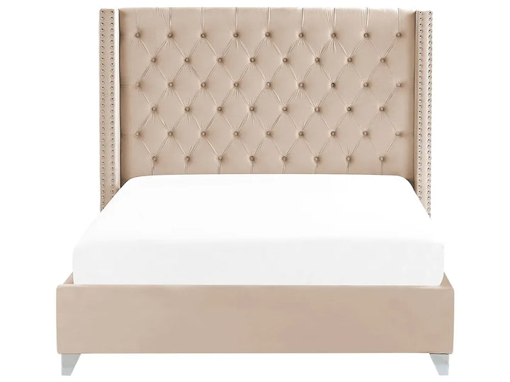 Beige upholstered bed with tufted headboard on a white background