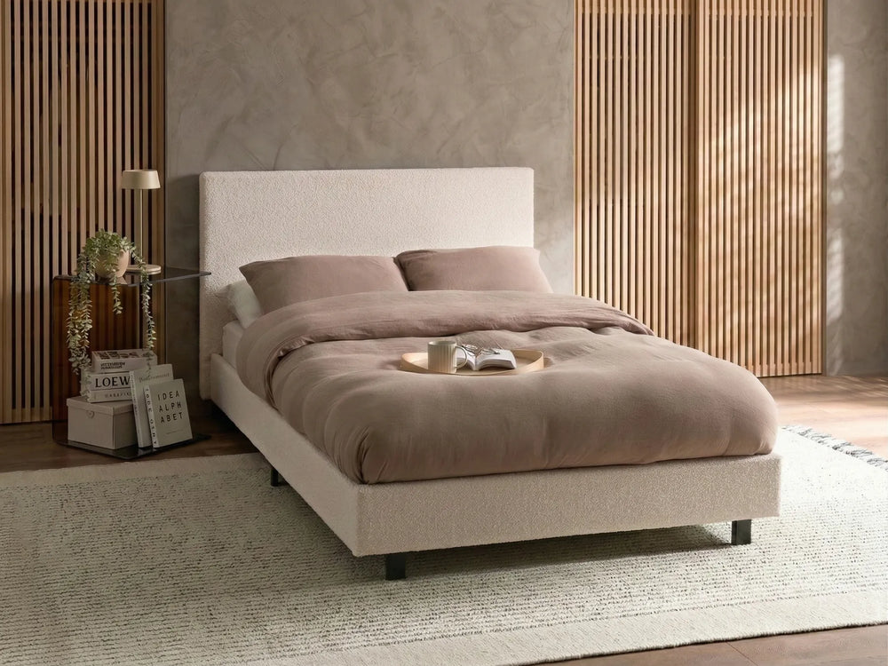 Minimalist boucle bed in neutral bedroom setting