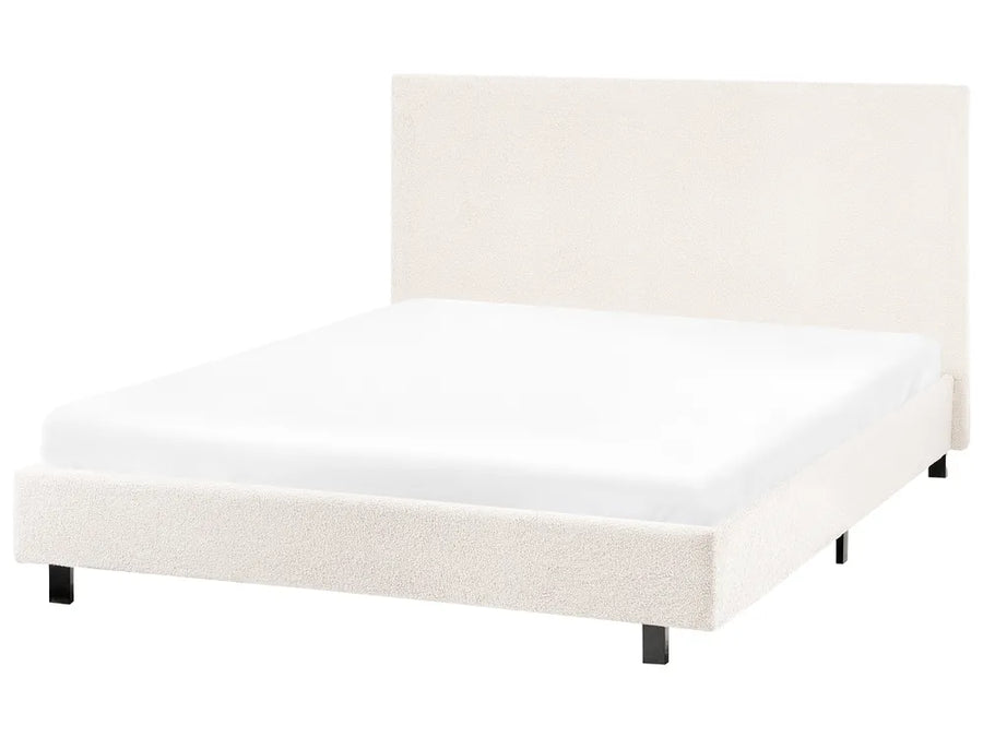 White upholstered bed frame on a white background