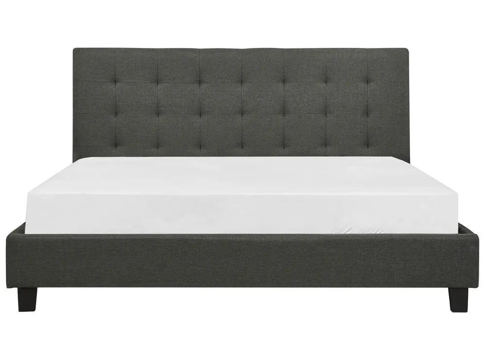 Dark gray upholstered bed with white mattress on a white background