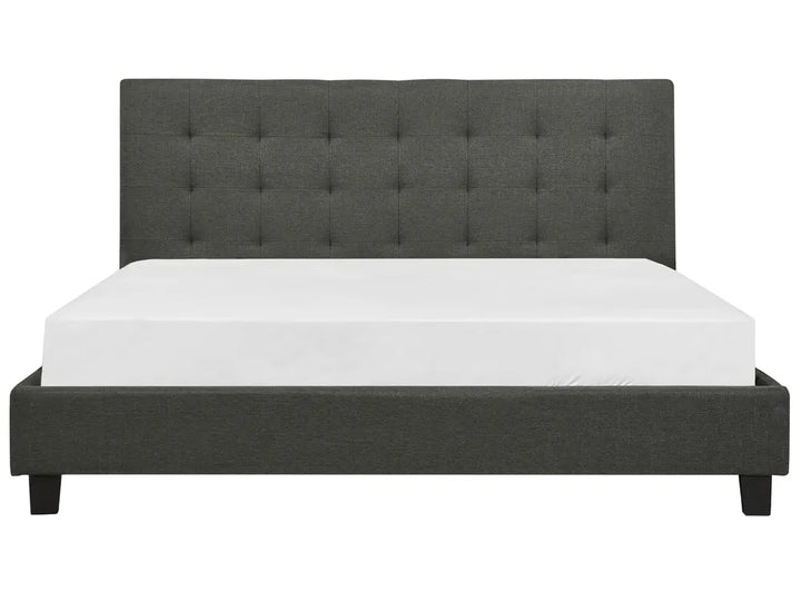 Dark gray upholstered bed with white mattress on a white background