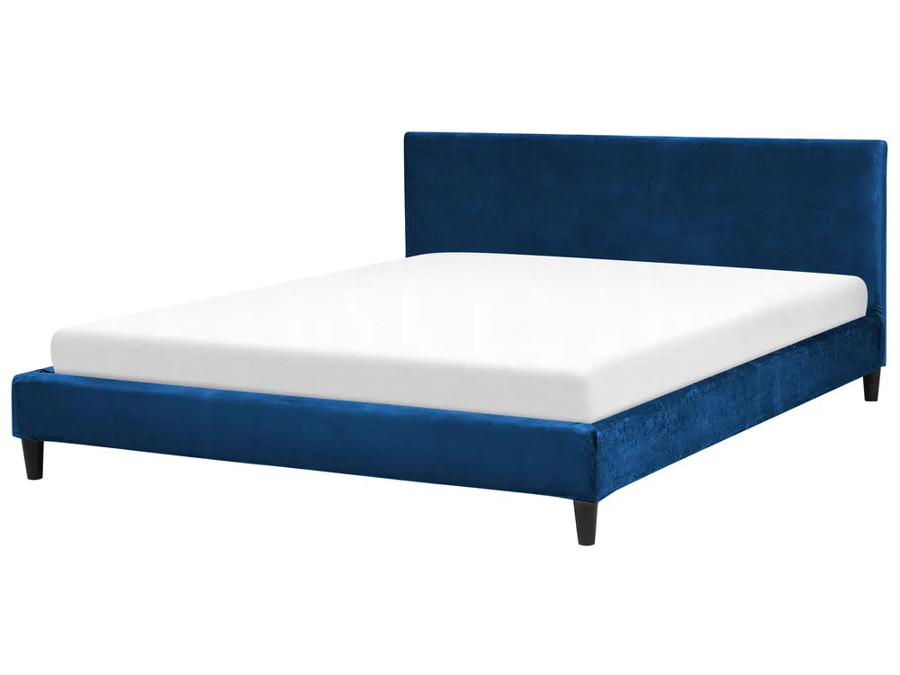 Pink upholstered bed with white mattress on a white background
