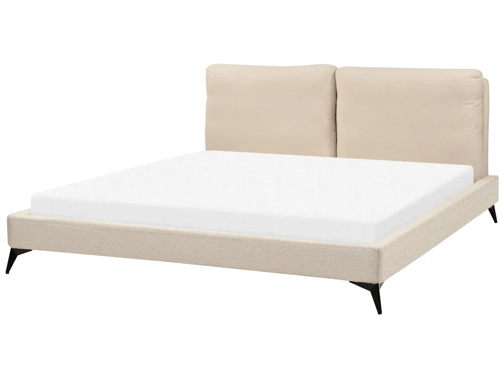 Beige upholstered bed with white mattress on a white background