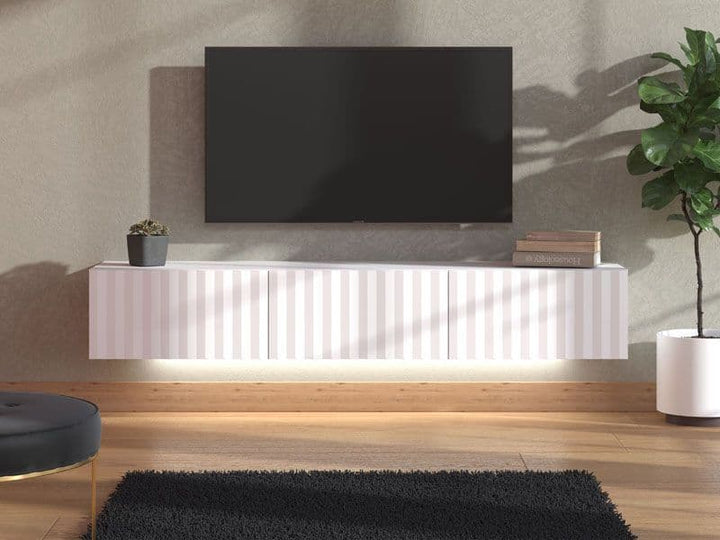 Modern living room with a white entertainment console, TV, and decorative items.