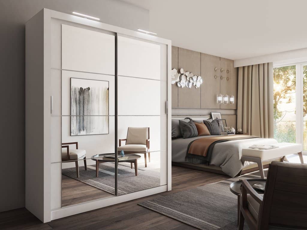 Modern bedroom with a wardrobe, bed, and chairs.