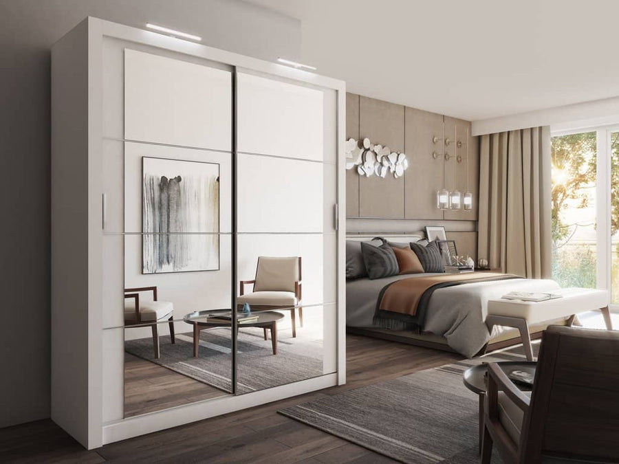 Modern bedroom with a wardrobe, bed, and chairs.
