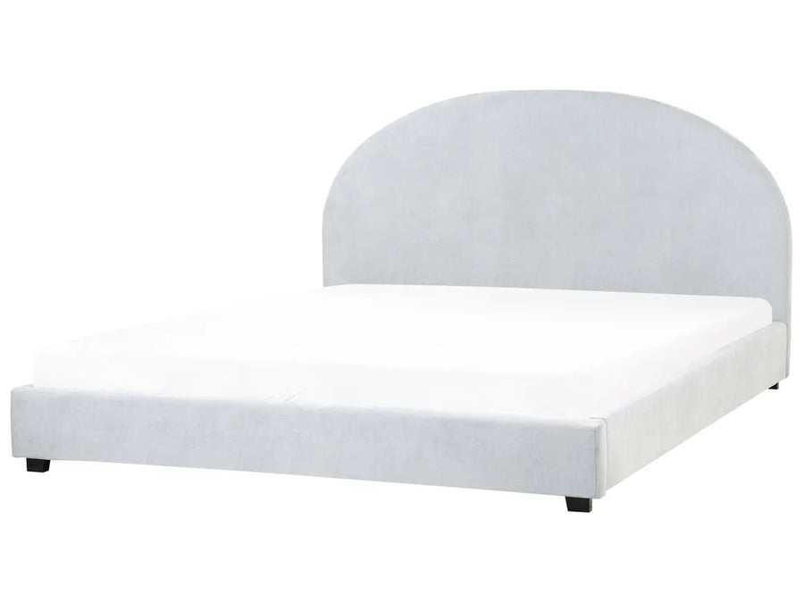 White upholstered bed frame on a white background