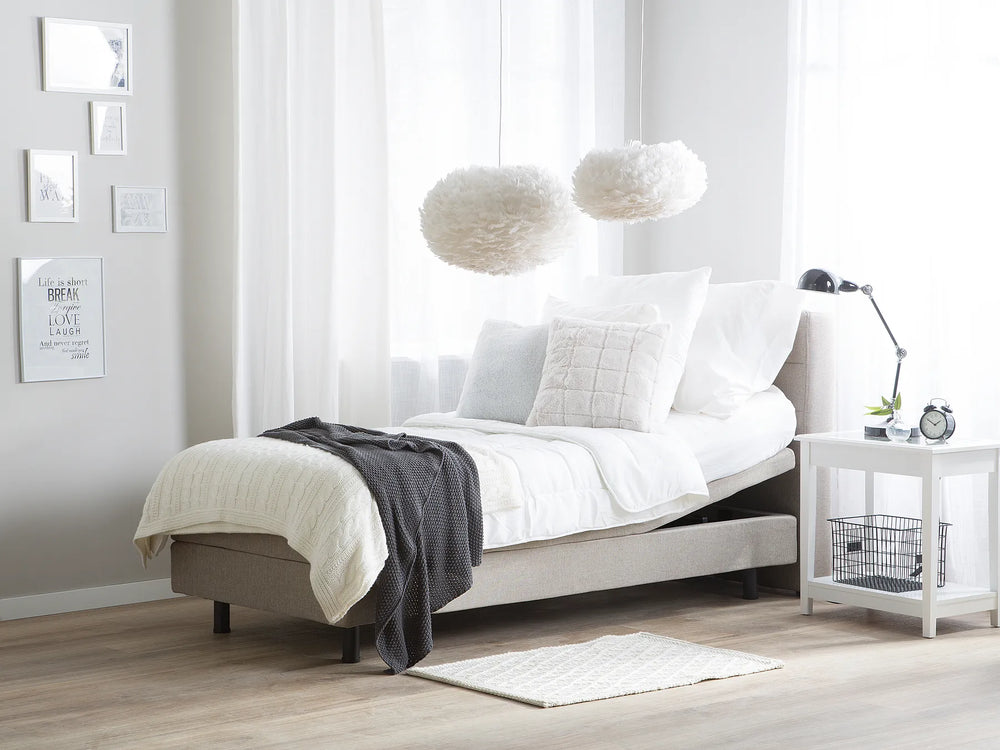 Modern bedroom with a bed, nightstand, and decorative elements.