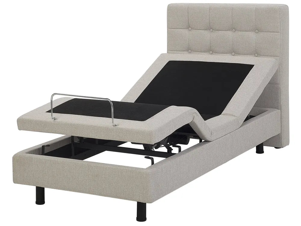Gray adjustable bed with black control panel on a white background