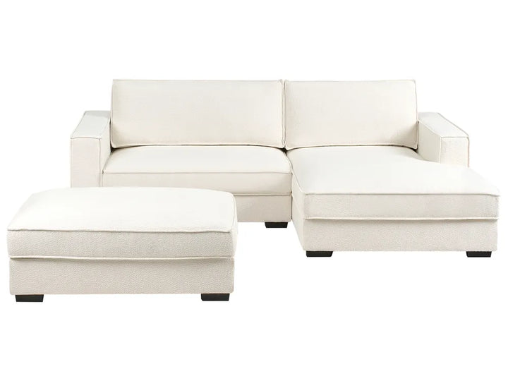 White sectional sofa with ottoman on a white background