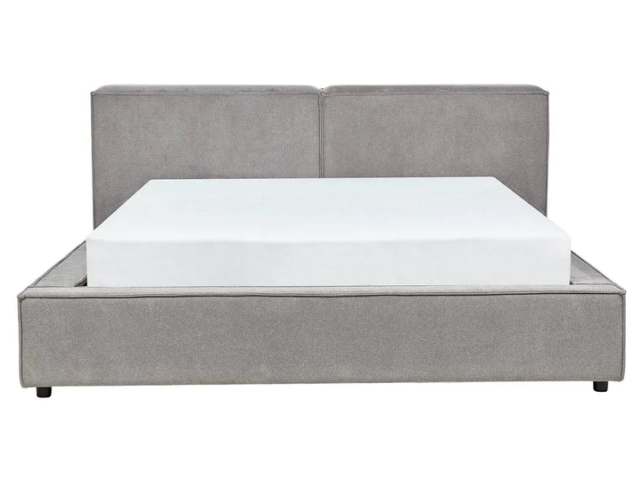 Gray upholstered bed with a white mattress on a white background