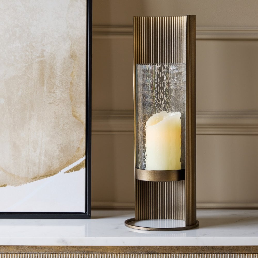 Decorative candle holder with a candle on a marble surface