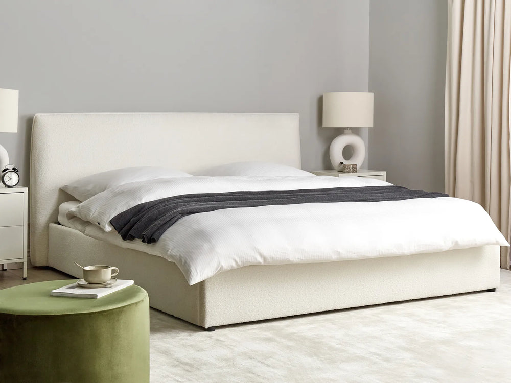 Modern bedroom with a white bed, nightstands, and lamps.