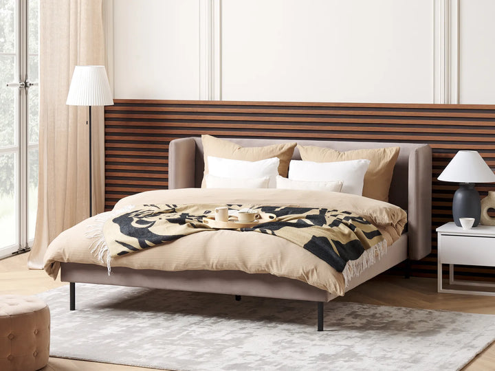 Modern bedroom with a bed, nightstands, and lamps.