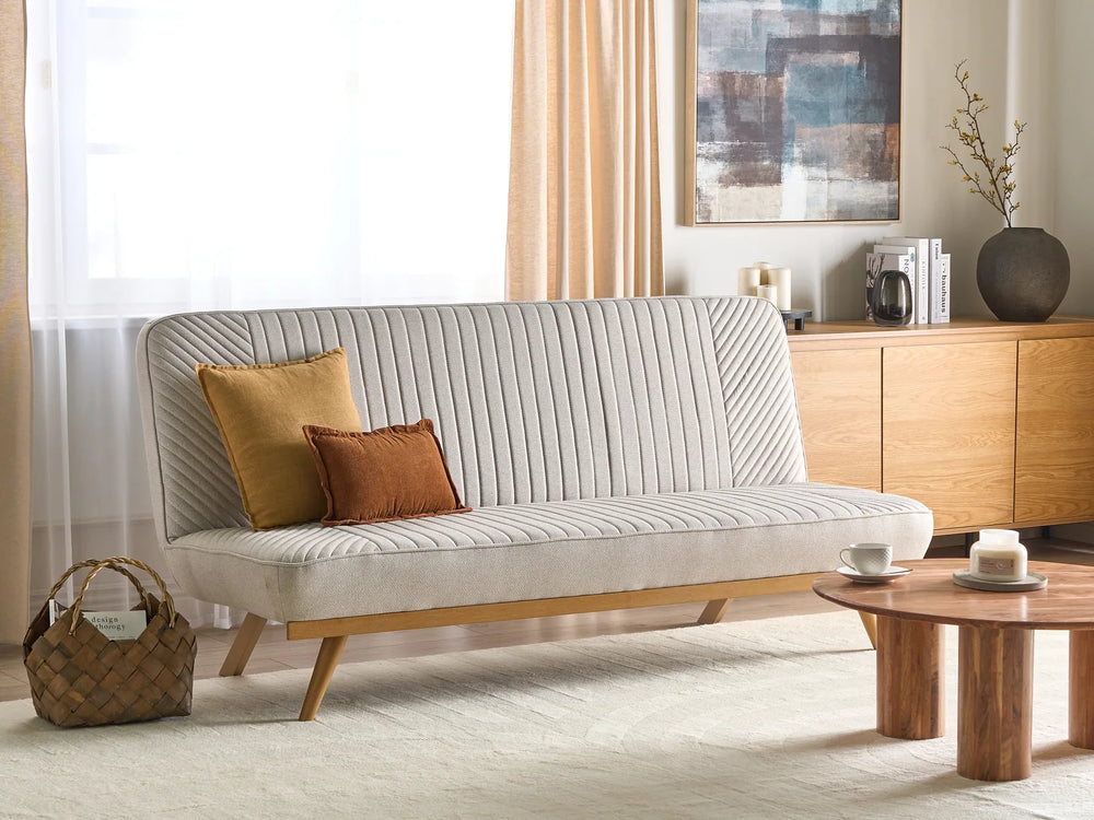 Gray sofa with two cushions in a living room setting