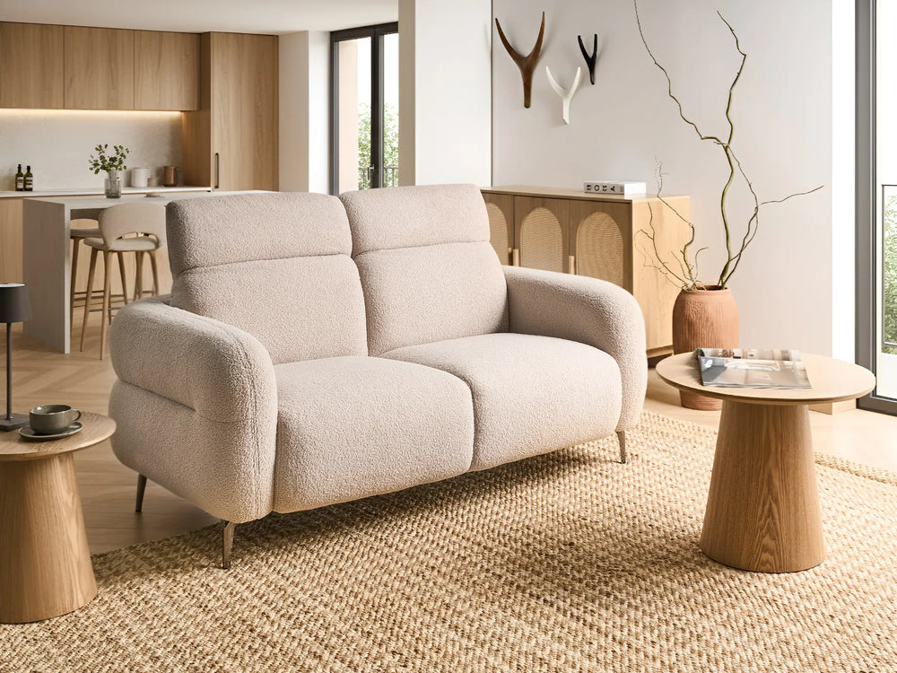 Beige sofa in a modern living room with wooden tables and decor.