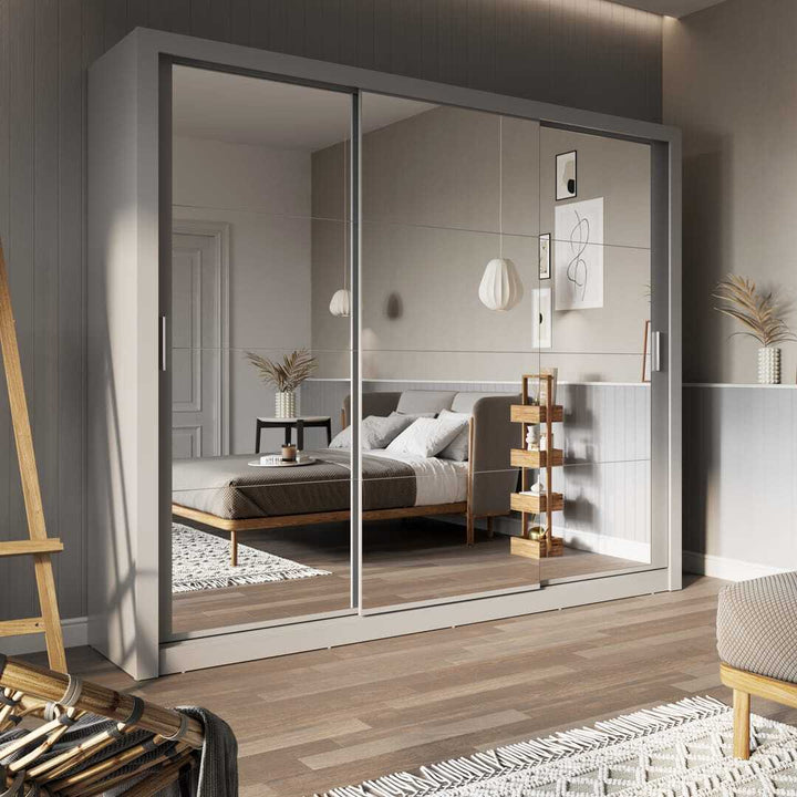 Modern wardrobe with sliding mirror doors in a bedroom setting