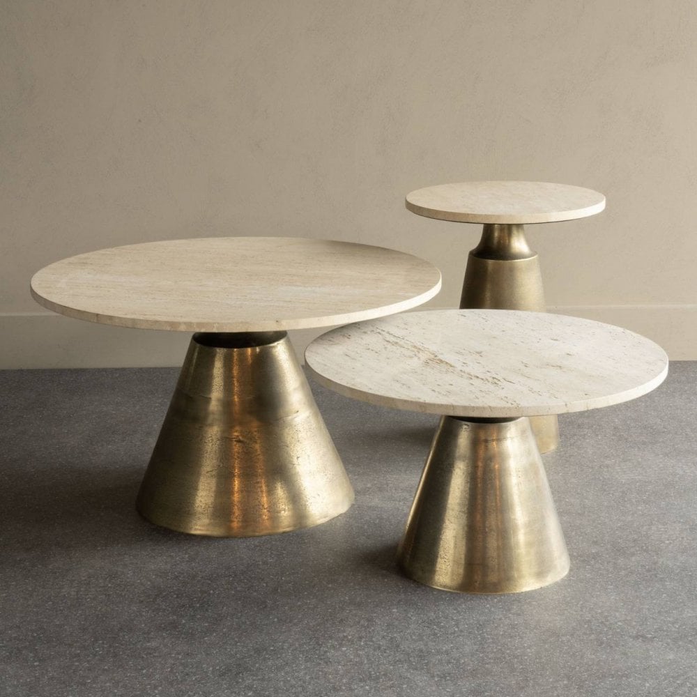 Three marble top tables with brass cylindrical bases on a gray floor.