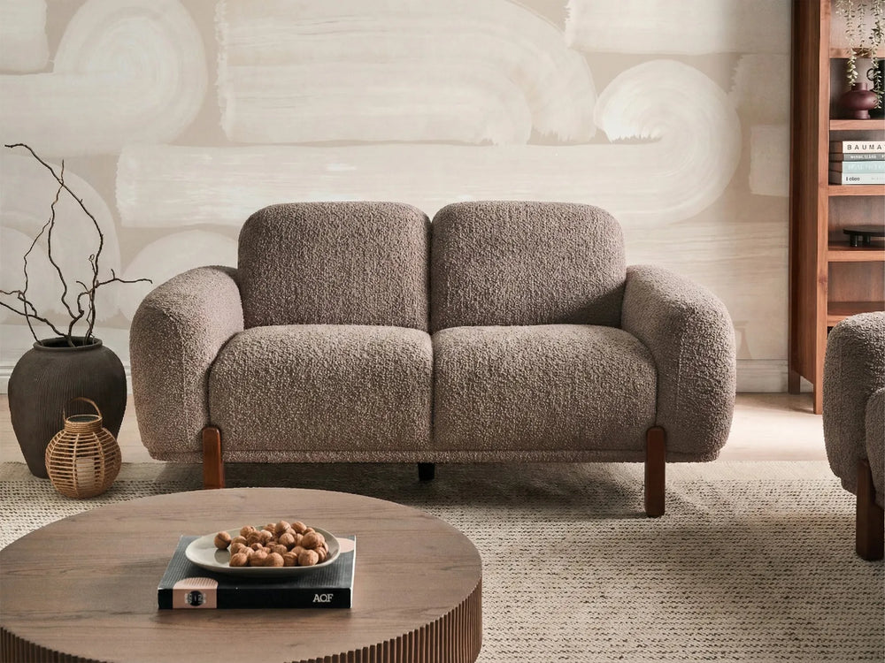 Taupe bouclé loveseat with curved design