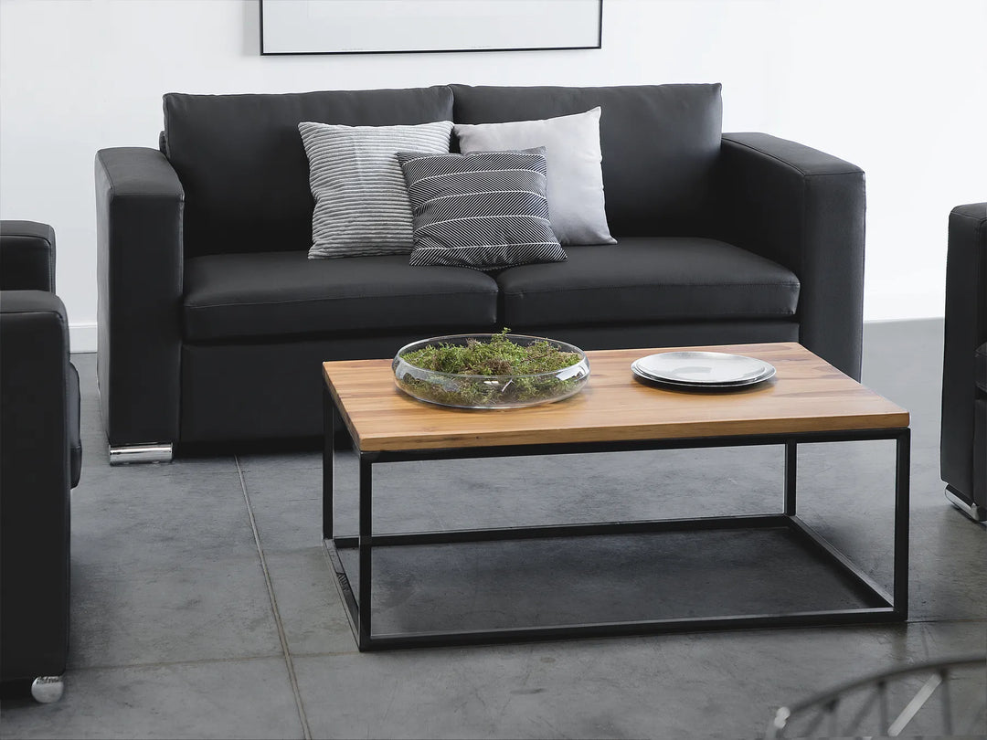 2 seater black leather sofa with padded seats and modern design