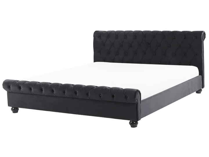 Black tufted bed with white mattress on a white background