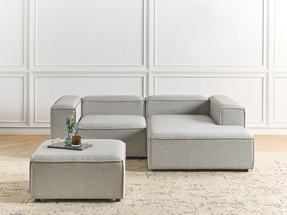 3-seater light grey L-shaped fabric sofa with chaise and ottoman, soft upholstery and contemporary design