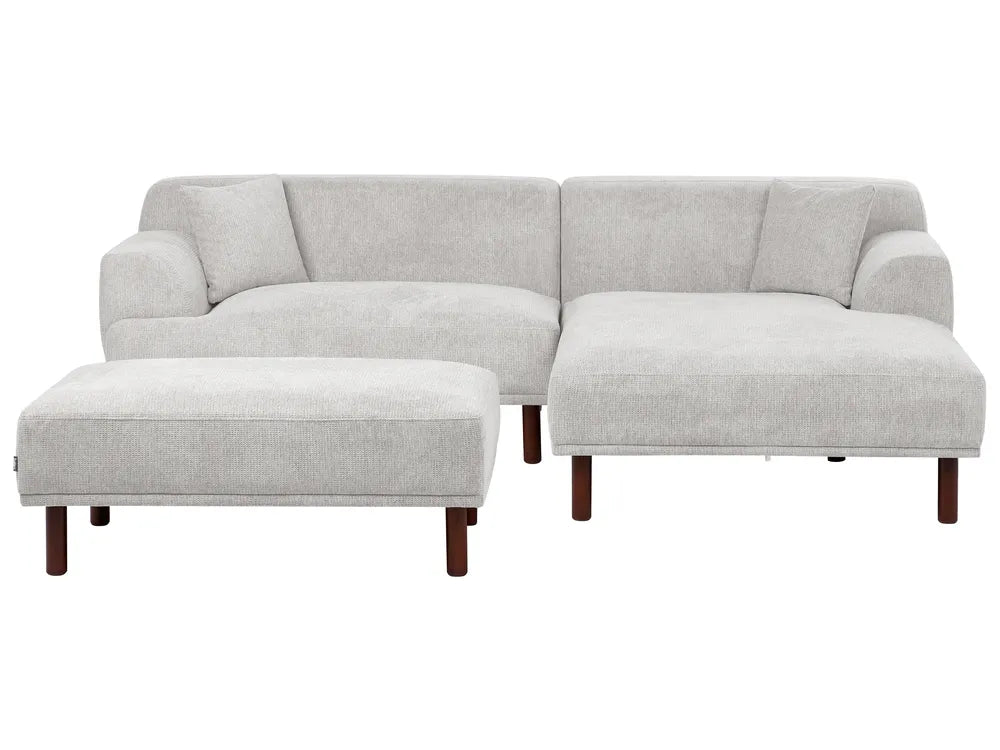 Gray sectional sofa with ottoman on a white background