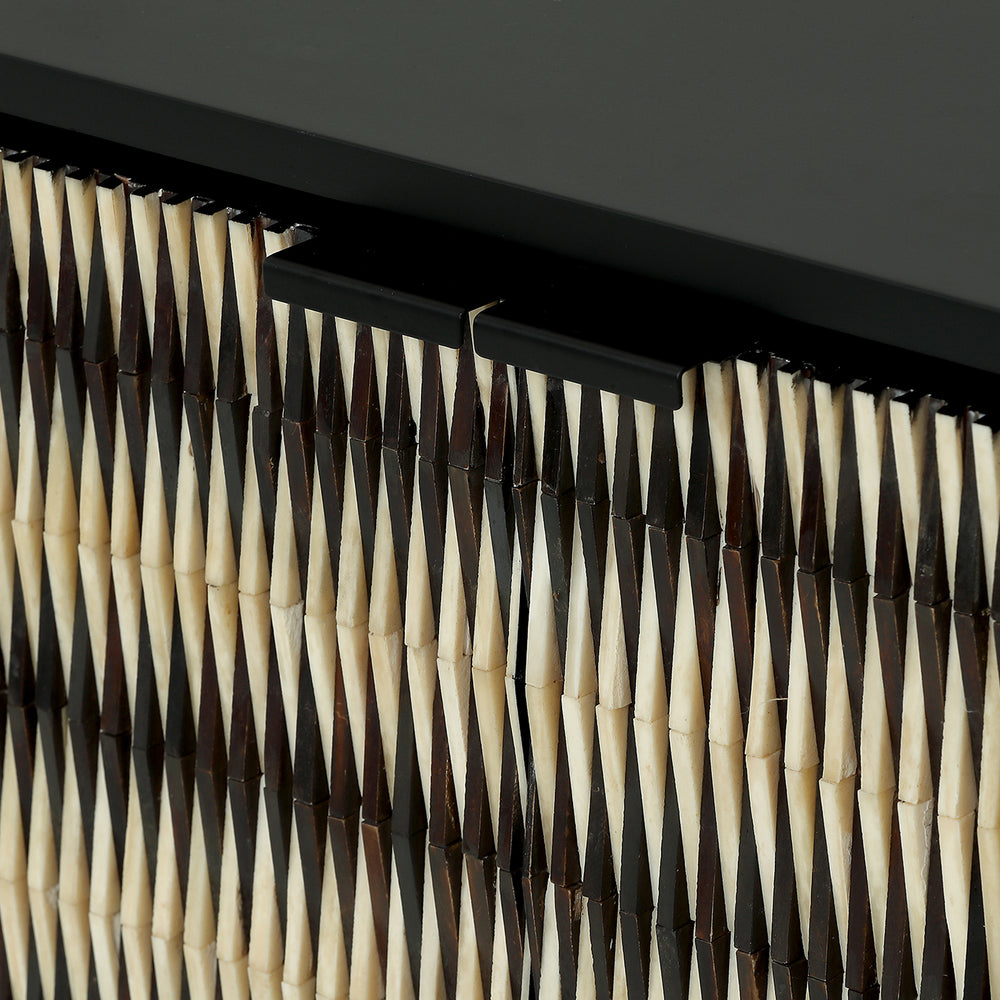 Close-up of a wicker basket with a black metal frame against a dark background