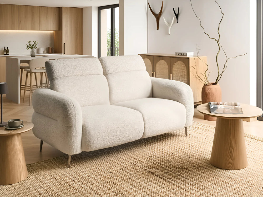 White sofa in a modern living room with wooden tables and decor.