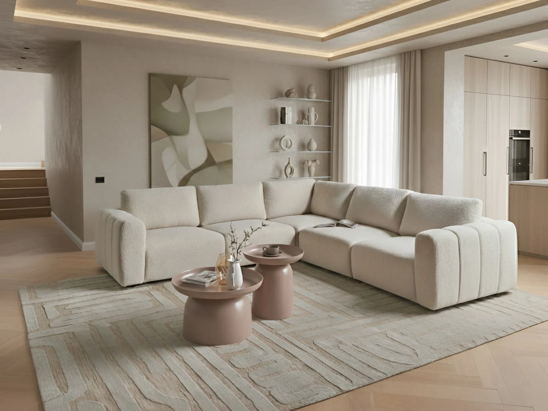 Modern left-hand bouclé corner sofa in off-white with modular sections and ottoman