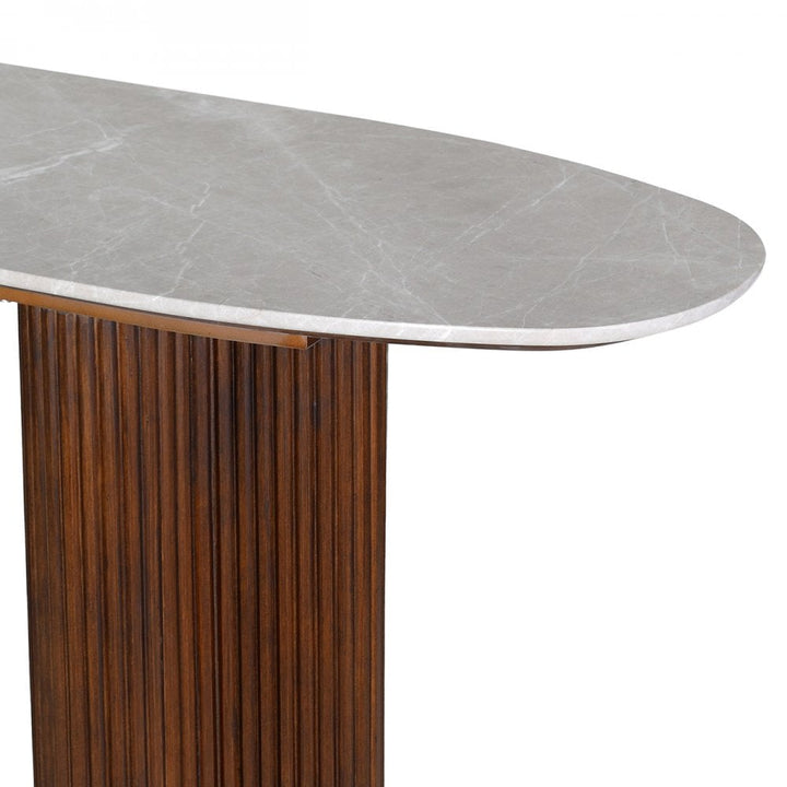 Dining table with marble-like top and wooden base on a white background