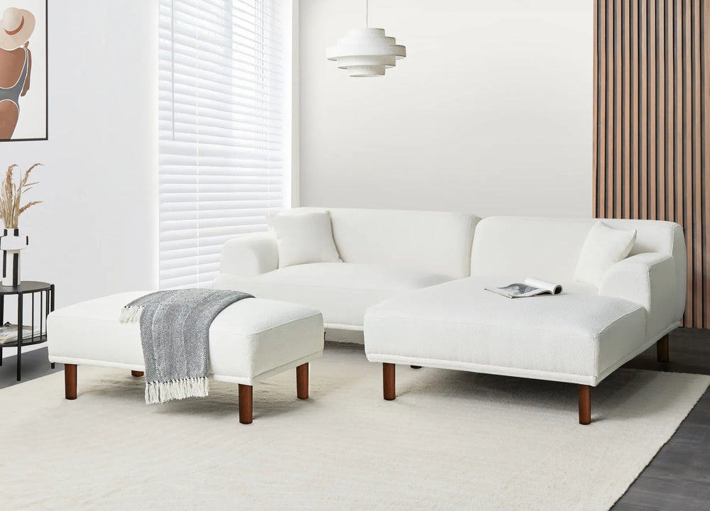 White sectional sofa in a modern living room with a neutral color scheme.