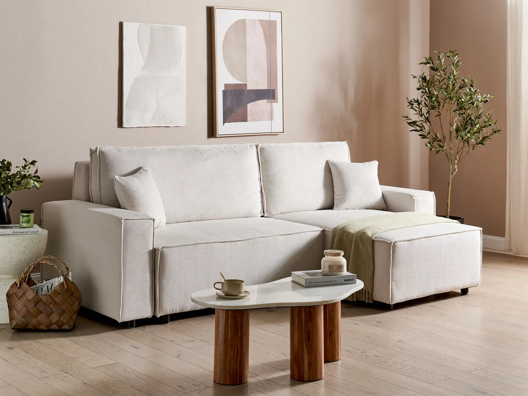 Modern living room with a white sofa, wooden coffee table, and decorative elements.