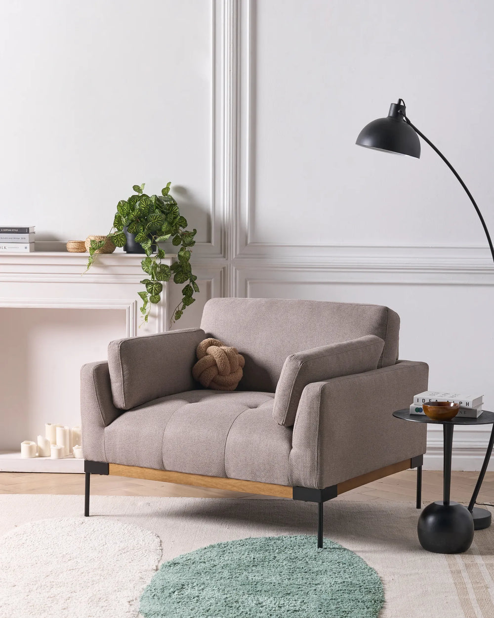 Gray sofa in a modern living room with a lamp and plant