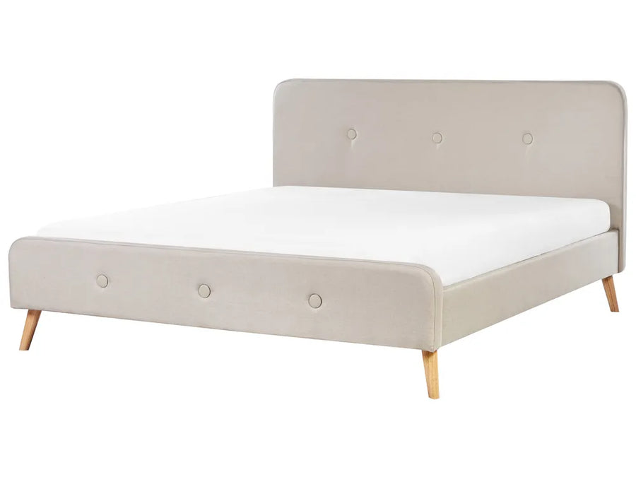 Beige upholstered bed with white mattress on a white background