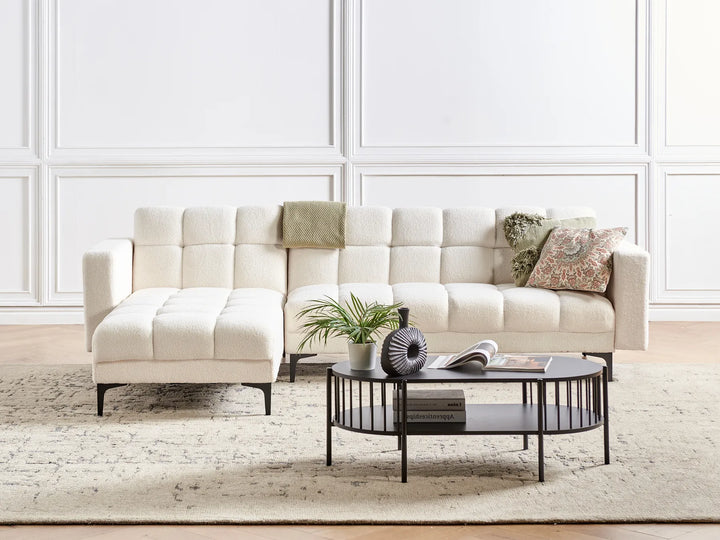 Beige sectional sofa with decorative pillows in a living room setting.