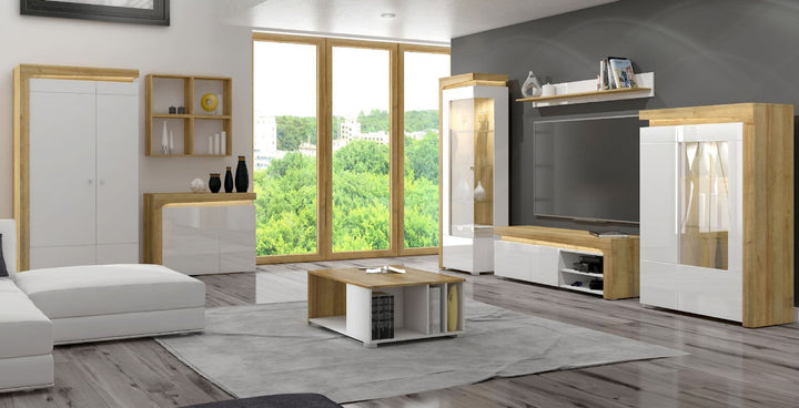 Modern living room with white and wood furniture, large window, and outdoor view.