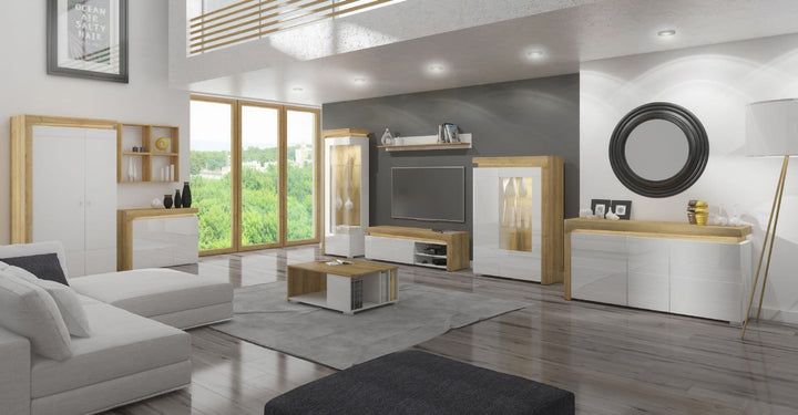 Modern living room with white sofa, coffee table, and entertainment unit.