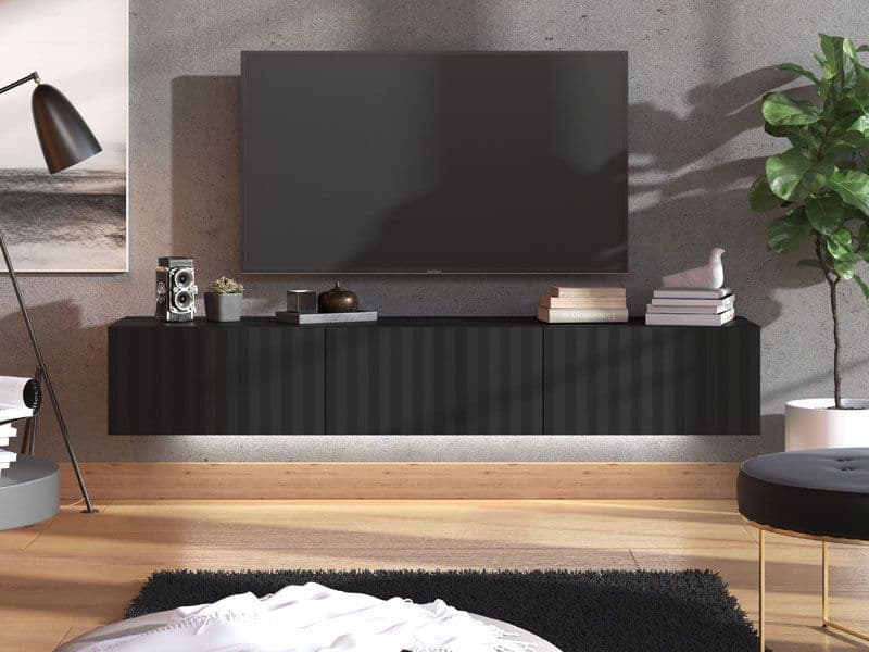 Modern living room with a black TV stand, television, and decorative items.