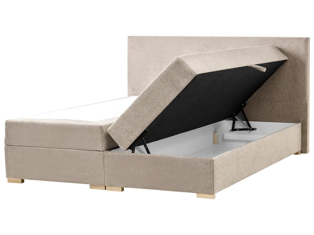 Beige upholstered bed with open storage compartment on a white background