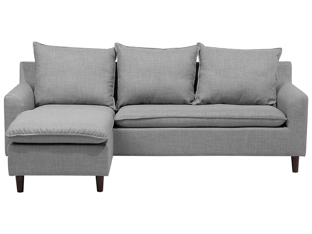 Gray sectional sofa with three cushions on a white background