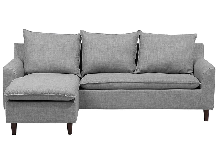 Gray sectional sofa with three cushions on a white background