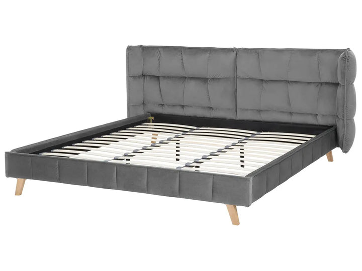 Gray upholstered bed with wooden legs on a white background