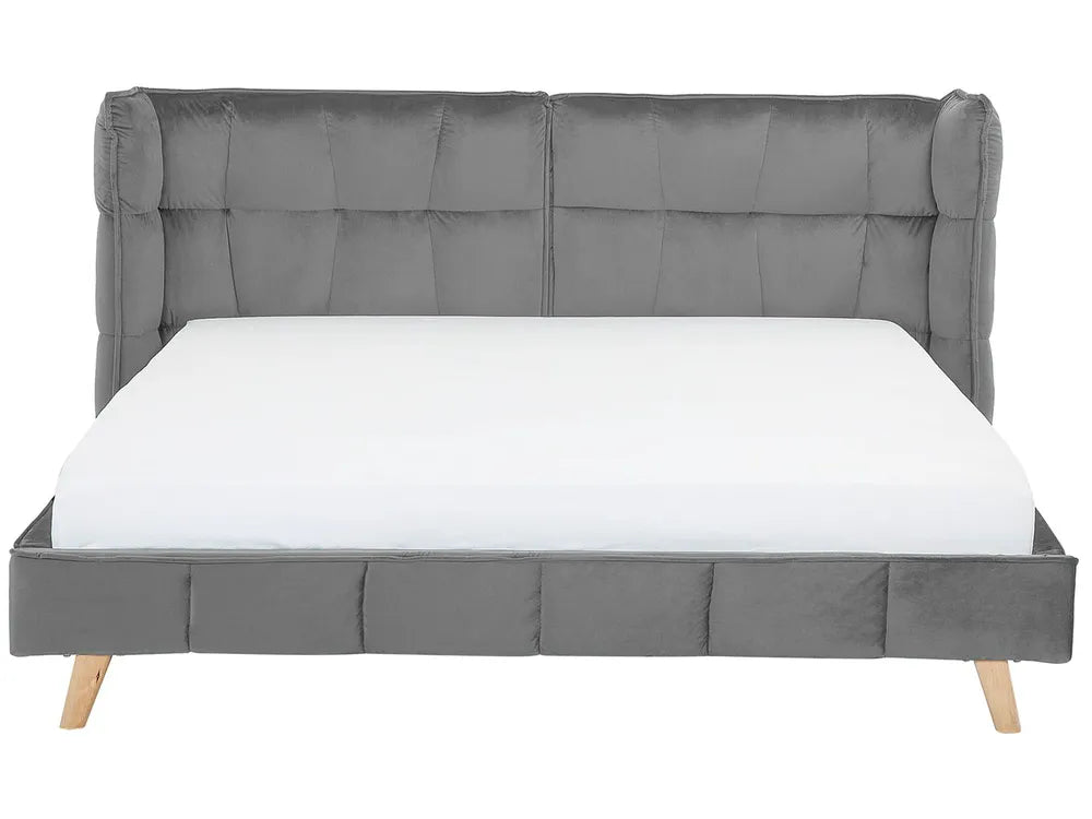 Gray upholstered bed with a tufted headboard on a white background
