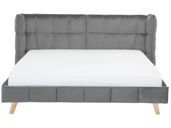 Gray upholstered bed with a tufted headboard on a white background