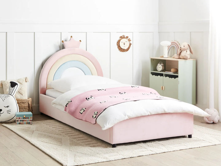Pink children's bed with rainbow design in a room setting